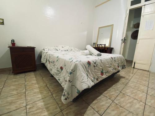 a bedroom with a bed and a table and a mirror at Aldeia Hostel in Manaus