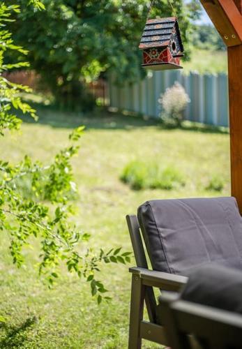 a bird house is hanging from a porch at Mannana házikó in Szokolya
