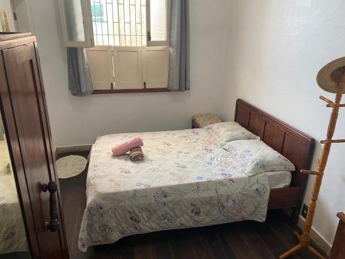 a bedroom with a bed with a doll on it at Aldeia Hostel in Manaus
