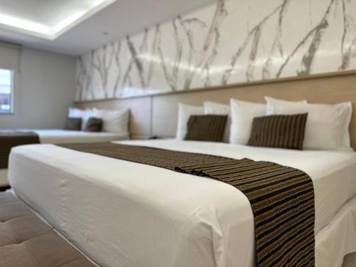 a large bed in a room with two beds at Atrium Confort Hotels in Parauapebas