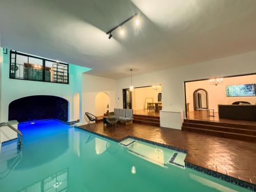 a large swimming pool in a living room at Riverside House with Indoor Pool in Johannesburg