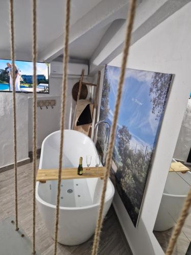 a bathroom with a white tub in a room at El Pitijopo in El Gastor