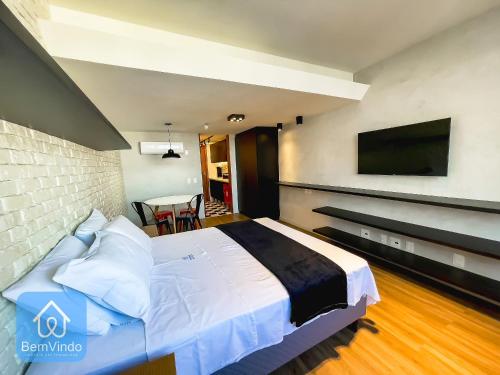 a bedroom with a large bed and a tv on the wall at Apartamento completo com píer e acesso ao mar in Salvador