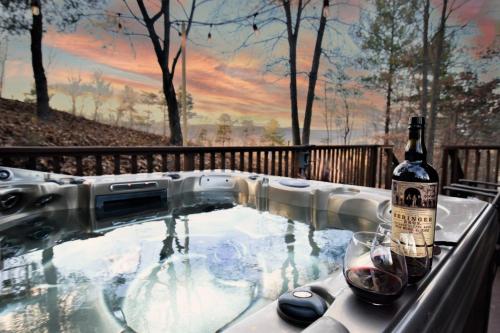 a hot tub with a bottle of wine and a glass at Free Resort Passes - Hot Tub - Sauna - Views - Fast Wi-Fi - Pet Friendly in Basye