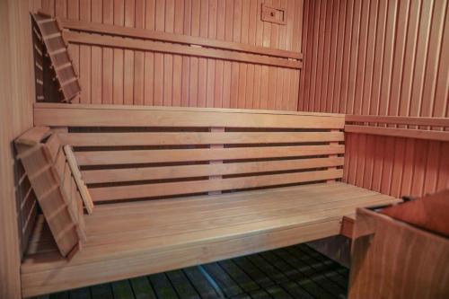 an empty sauna with a wooden bench in it at Studio Apartments Visit Point in Sarajevo