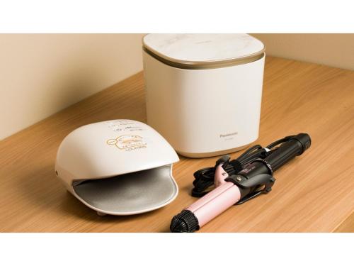 a helmet and a camera on a table next to a container at GRIDS Premium Hotel Otaru - Vacation STAY 68545v in Otaru