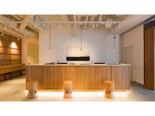 a large room with a stage and stools at GRIDS Premium Hotel Otaru - Vacation STAY 68534v in Otaru