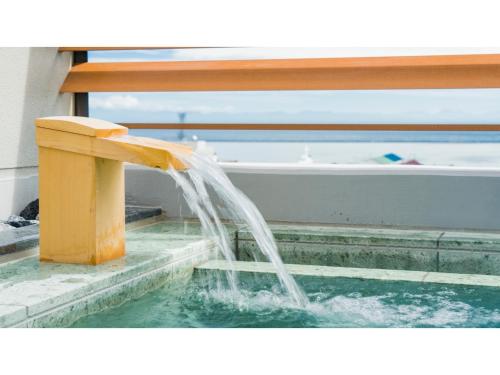 a water fountain in front of a boat at GRIDS Premium Hotel Otaru - Vacation STAY 68543v in Otaru