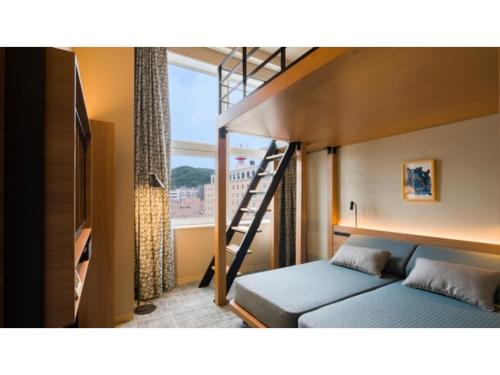 a bedroom with a bunk bed with a ladder at GRIDS Premium Hotel Otaru - Vacation STAY 68539v in Otaru