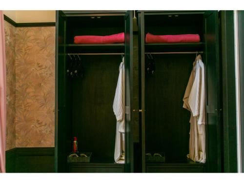 a closet with green doors and towels in it at Restaurant & Hotel Traumerei - Vacation STAY 47760v in Hakuba