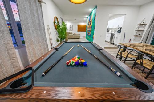 a pool table with balls on it in a living room at Tulum Villa in Miami