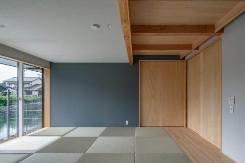 Habitación vacía con armarios de madera y ventana grande. en Muginowa - Vacation STAY 38280v en Kuwana