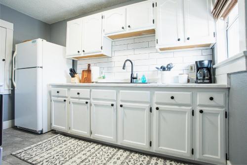 a kitchen with white cabinets and a white refrigerator at Historic Apt Mins to Beach, Convention Center, Downtown w Free Parking in Long Beach