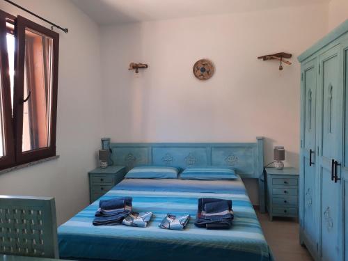 ein Schlafzimmer mit einem blauen Bett und Handtüchern darauf in der Unterkunft Villa Margherita vista mare in Torre Dei Corsari