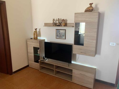 a entertainment center with a flat screen tv on a wall at Mediterranean Sunset Villa in Punta Braccetto
