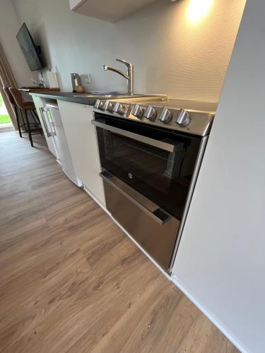 a kitchen with a stainless steel stove and a sink at Go-Sleep Bredehus in Bredsten