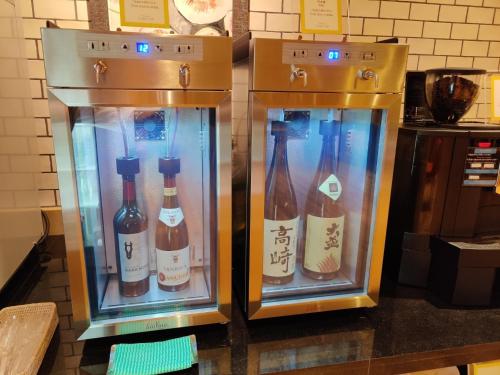 two refrigerators with bottles of wine in them at Hotel Grand View Takasaki - Vacation STAY 55422v in Takasaki
