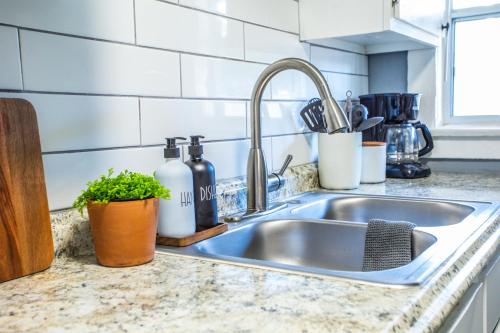 a kitchen counter with a sink in a kitchen at Charming Historic Apartment Mins to Convention Center, Beaches and Downtown Attractions in Long Beach