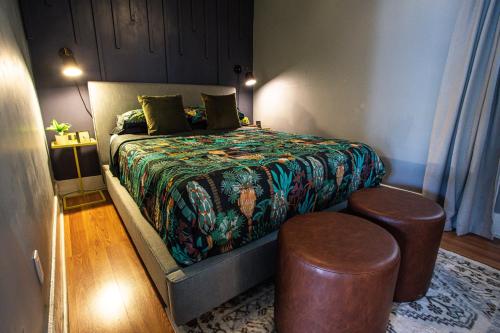 a bedroom with a bed with two stools in it at Charming Historic Apartment Mins to Convention Center, Beaches and Downtown Attractions in Long Beach