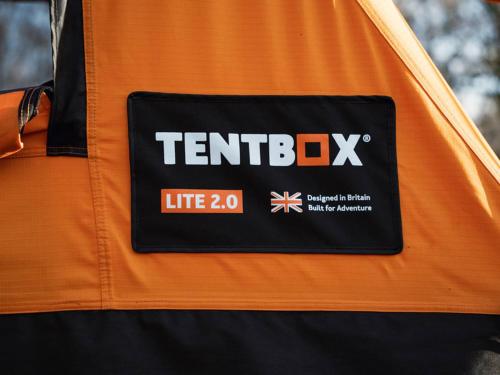 a sign on the side of an orange and black jacket at Tentbox Lite 2.0 in Thorpe le Soken