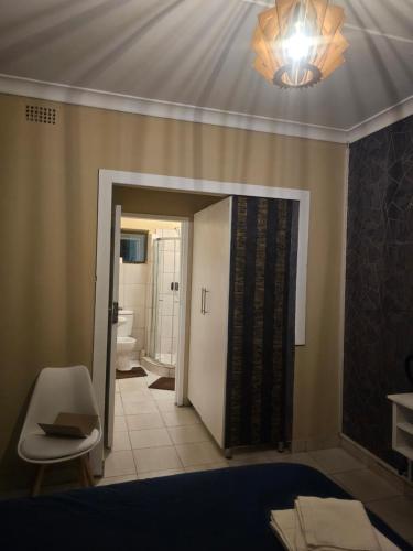 a room with a bathroom with a light on the ceiling at YELLO GUEST HOUSE CE2 in Vanderbijlpark