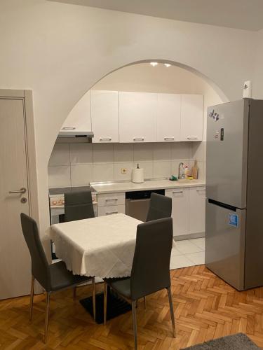 a kitchen with a table and chairs and a refrigerator at Apartment Tilia Center Belgrade in Belgrade