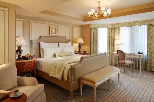 a bedroom with a bed and a chair and a couch at The Jefferson Hotel in Washington, D.C.