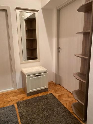 a room with a cabinet and a mirror and a door at Apartment Tilia Center Belgrade in Belgrade