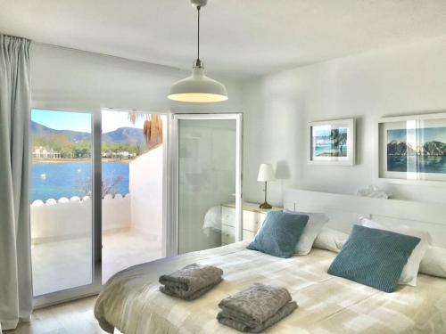 a bedroom with a large bed with two pillows on it at CASA PRINCESA in Alcudia