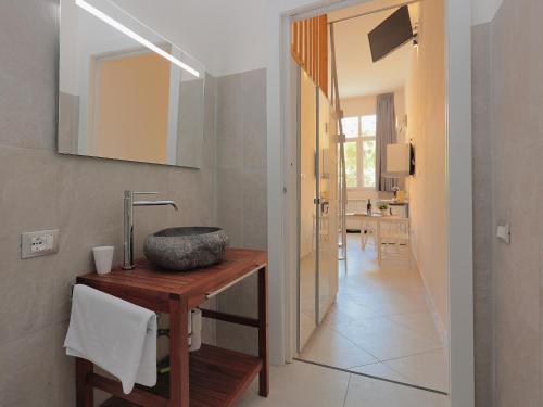 a bathroom with a sink and a mirror at La Ca' Fiera Affittaly Apartments in Bologna