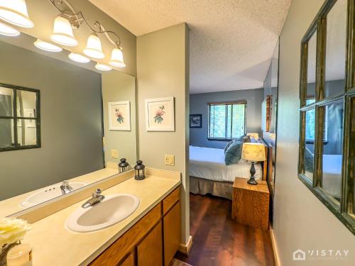 a bathroom with a sink and a bed in a room at Premium Ski In Ski Out At Giants Steps Chairlift! in Brian Head