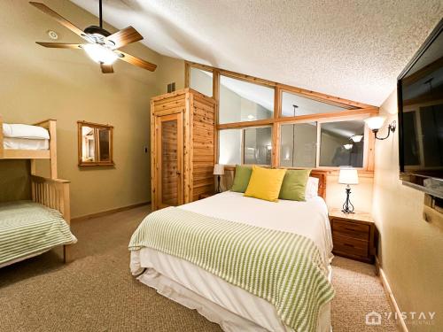 a bedroom with a bed and a television in it at Premium Ski In Ski Out At Giants Steps Chairlift! in Brian Head