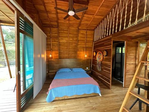 a bedroom with a bed in a wooden cabin at Eco Hotel Samaria , Aguas y Bosques in San Rafael