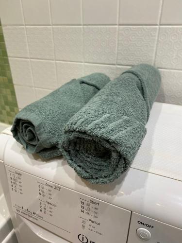 a green towel sitting on top of a box at Smelte Studio Apartment in Klaipėda