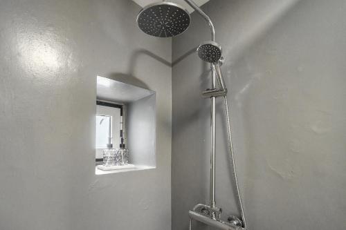 a shower in a bathroom with a mirror at WHome Urban Escape: 1-BR w/mezzanine near Campo Ourique in Lisbon