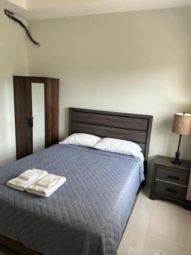 a bedroom with a bed with a towel on it at Mandeville Vacation Home in Mandeville