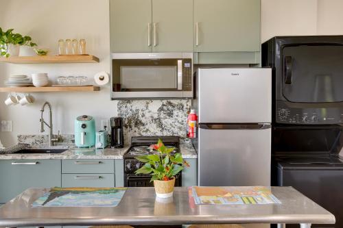 a kitchen with a stainless steel refrigerator and a table at Dale Hollow Sunset Studio with Incredible Views! in Celina