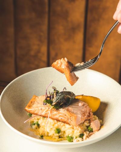 a plate of food with a piece of food on a fork at Carnmore Hotel Christchurch in Christchurch