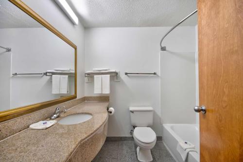 a bathroom with a sink and a toilet and a mirror at Motel 6 Walton, KY - Richwood - Cincinnati Airport South in Walton