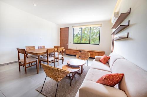 a living room with a couch and a table at Deluxe Apartments Azure in Bacalar