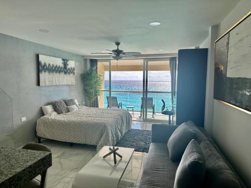 a living room with a bed and a couch at Beachfront Penthouse (best location, 3 beds, 2 balconies) in Cancún