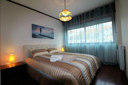 En eller flere senge i et værelse på Apartamento Figueira da Foz - Praia do Relógio