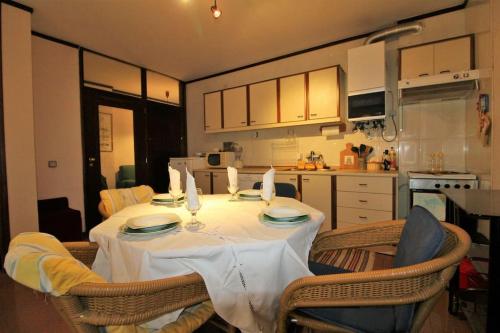a kitchen with a table with a white table cloth on it at Apartamento Figueira da Foz - Praia do Relógio in Figueira da Foz