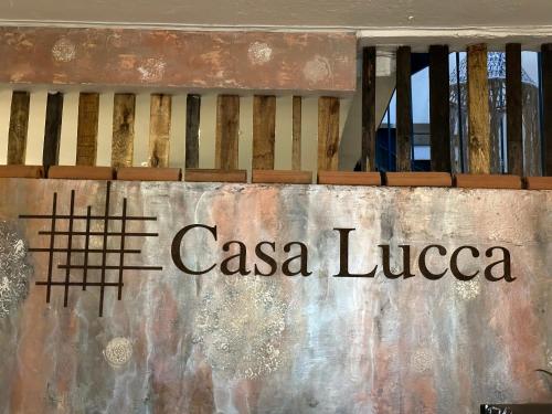 a sign that reads casa liceica on a wall at Hotel Casa Lucca in Medellín