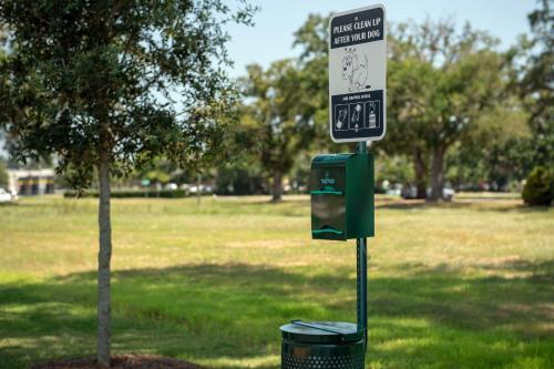 a street sign next to a tree in a park at Hilton Garden Inn Pensacola Downtown in Pensacola