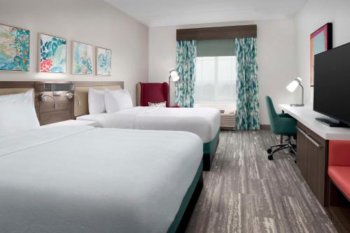 Habitación de hotel con 2 camas y TV de pantalla plana. en Hilton Garden Inn Pensacola Downtown, en Pensacola