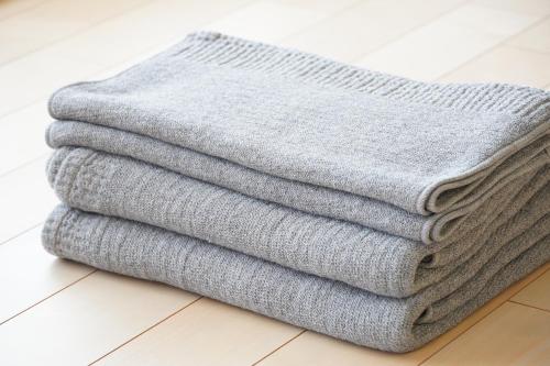 a pile of towels sitting on the floor at RIKKA HANASATO in Takayama