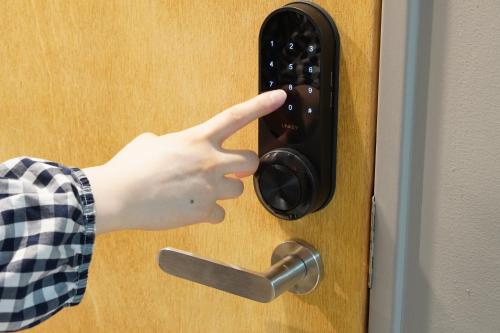 a person is pointing at a door handle at RIKKA HANASATO in Takayama