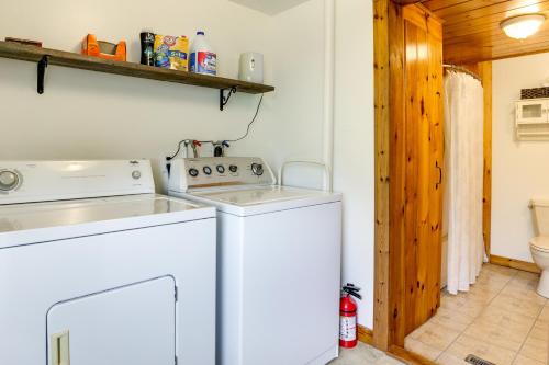 a white washer and dryer in a bathroom with a toilet at Cozy Exeter Vacation Rental with Grill and Fire Pit in West Greenwich