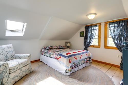 een slaapkamer met een bed, een stoel en een raam bij Cozy Exeter Vacation Rental with Grill and Fire Pit in West Greenwich